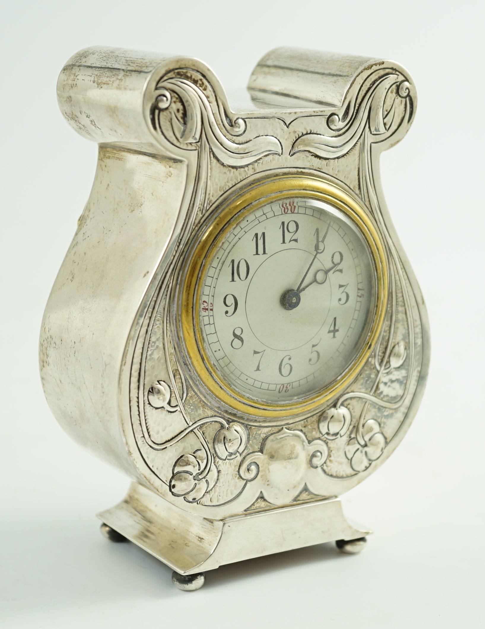 An Edwardian Art Nouveau silver cased mantel timepiece